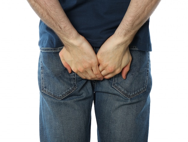 Man holding his butt, isolated