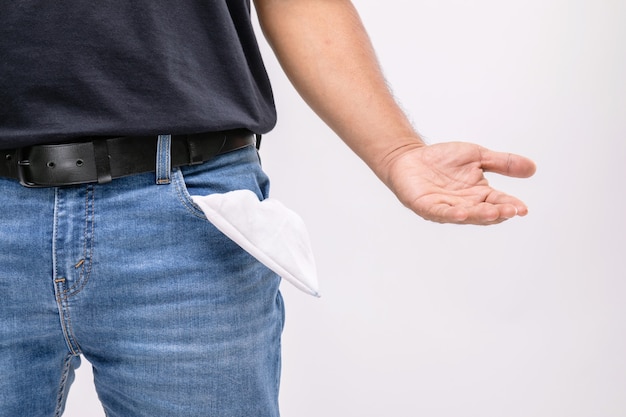 Man holding his pants pocket to show no money inside