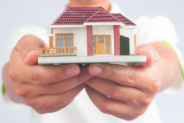 Man holding house model