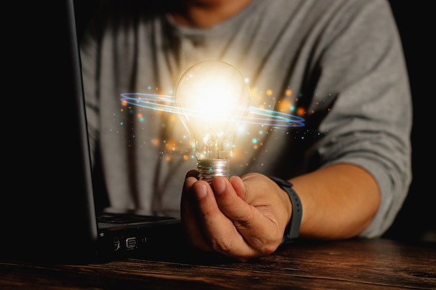 Man holding a light bulb Find new ideas With a view of cutting-edge technology and creativity