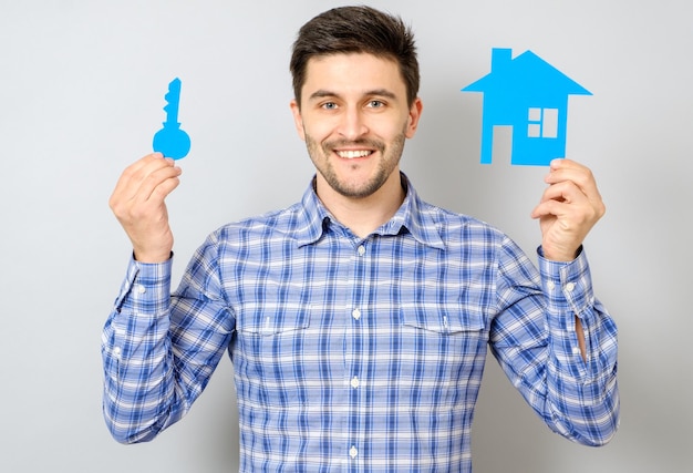 Man holding model of house Buying a house concept