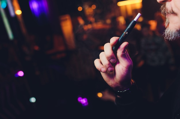 Man holding in one hand smoking module before smoking.