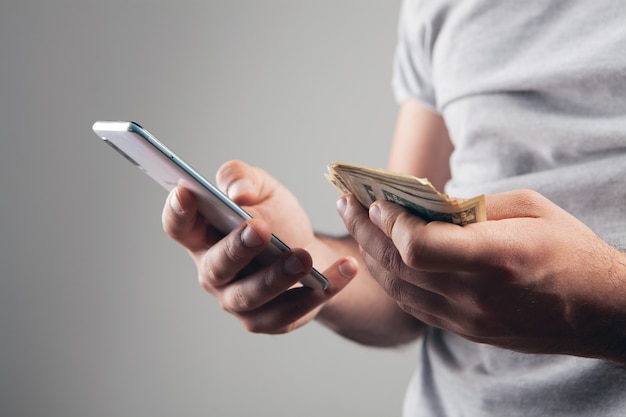 Man holding a phone and money. online shopping