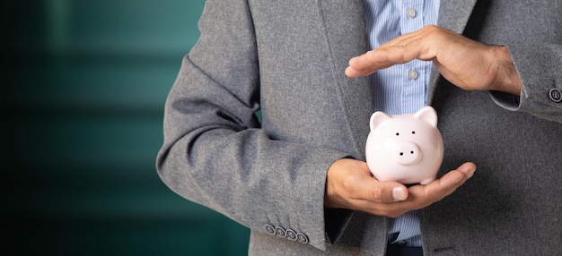 Man holding a piggy bank in his hand