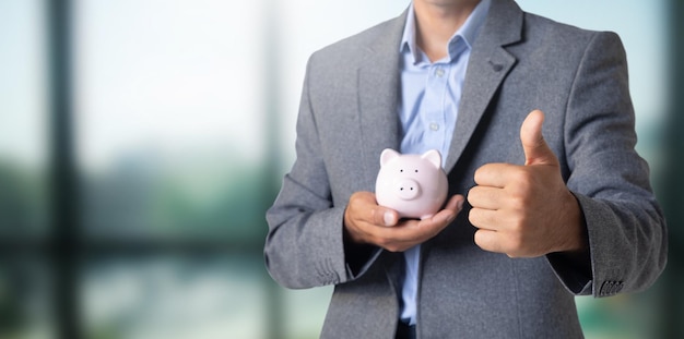 Man holding a piggy bank in his hand