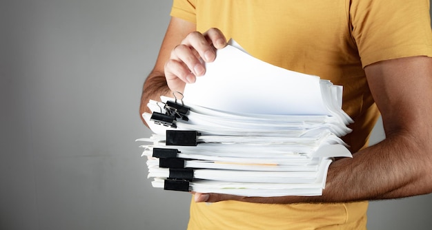 Man holding a pile of papers