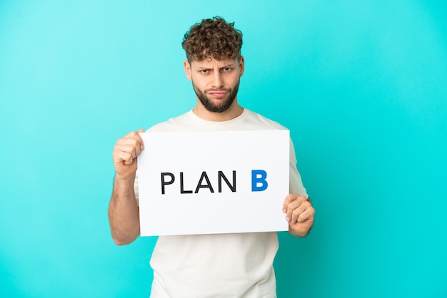 Man holding placard over isolated blue background