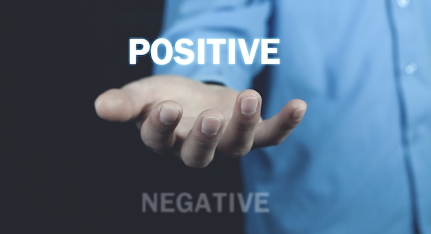 Man holding Positive and Negative words. Positive