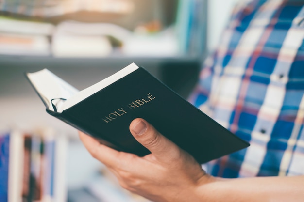 Man holding and reading the holy Christian Bible