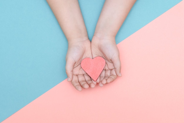 man holding a red heart