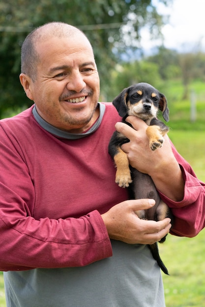 A man holding a small puppy