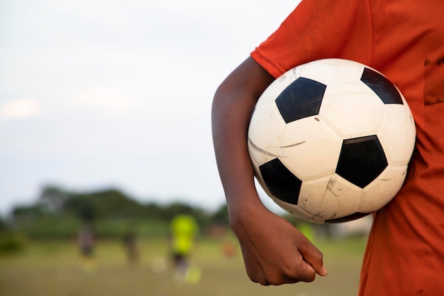 Man holding a soccer ball on the Play ground