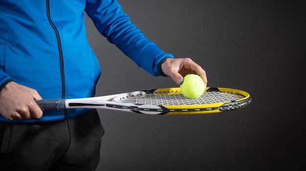 Man holding tennis ball and racket Sport Hobby