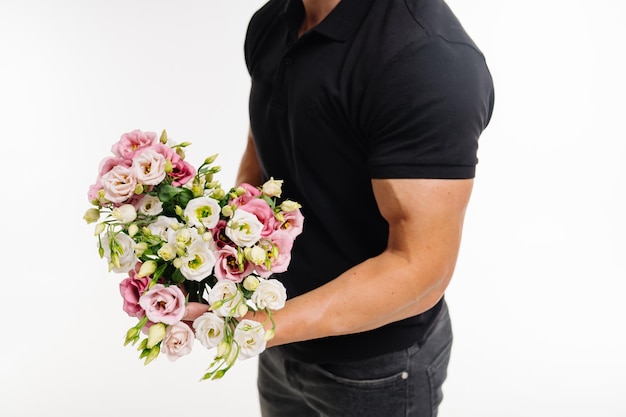 A man holding a vibrant bouquet of flowers A man is holding a bouquet of flowers