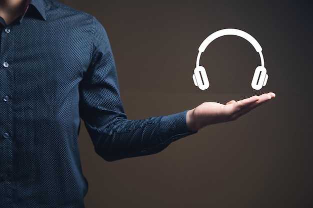 Man holding virtual wireless headphones