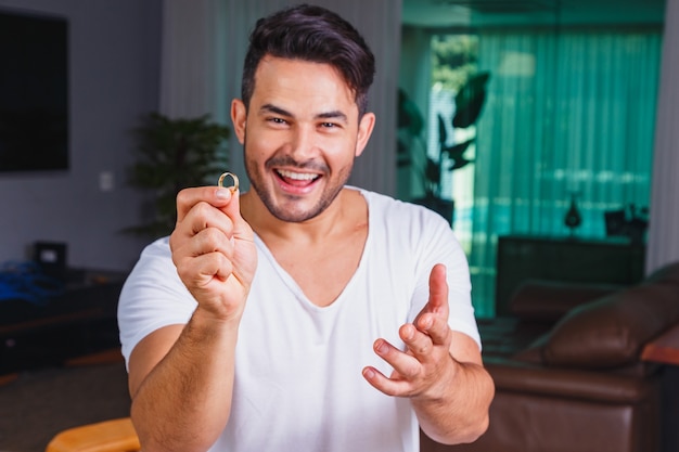 Man holding wedding ring in hand. Dating or marriage request concept