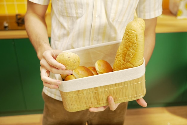 A man holds a basket of bread and bread.