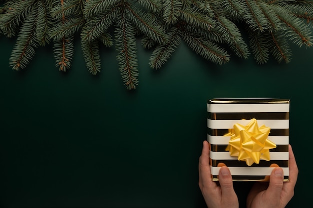 A man holds a Christmas present in his hands