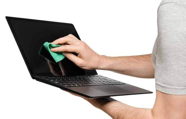 A man holds a laptop in one hand the other wipes the touch screen Isolate on a white background