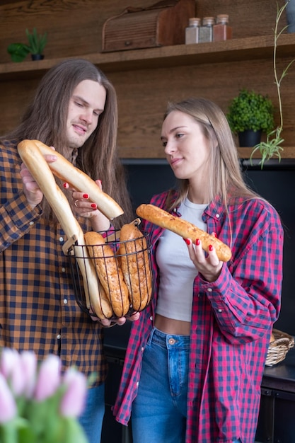 man holds metal basket full of loaves of bread Kitchen background Bakery advertisement Food poster