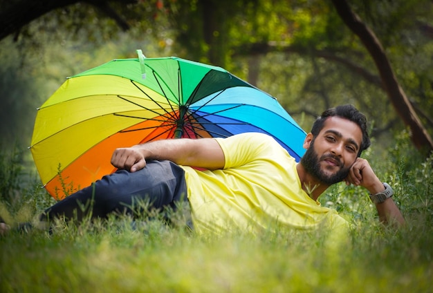 Man in holidays with umbrella outdoor