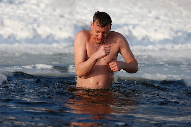 A man in an ice hole on the feast of the baptism of jesus