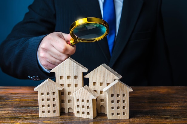 A man inspects houses Search for real estate for sale offers Property valuation Audit and revision of the city Checking the effectiveness of the work of authorities and city services