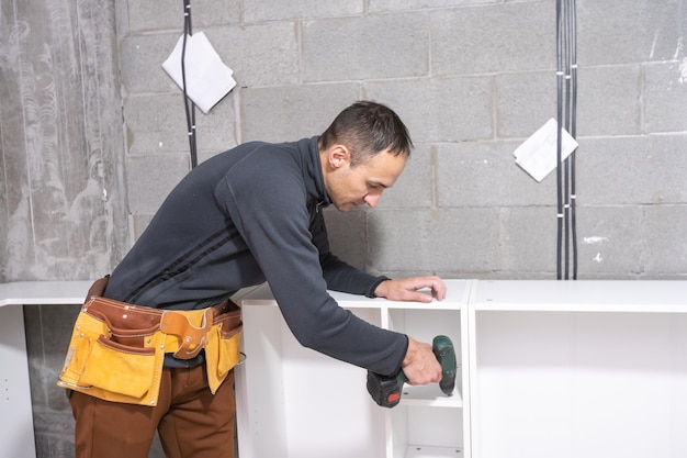 Man installs furniture in a new apartment.