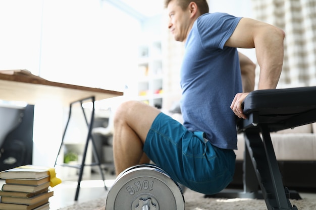 Man is doing physical exercises at home closeup