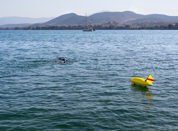 The man is engaged in scuba diving and hunting on Liani Ammos beach in Halkida Greece