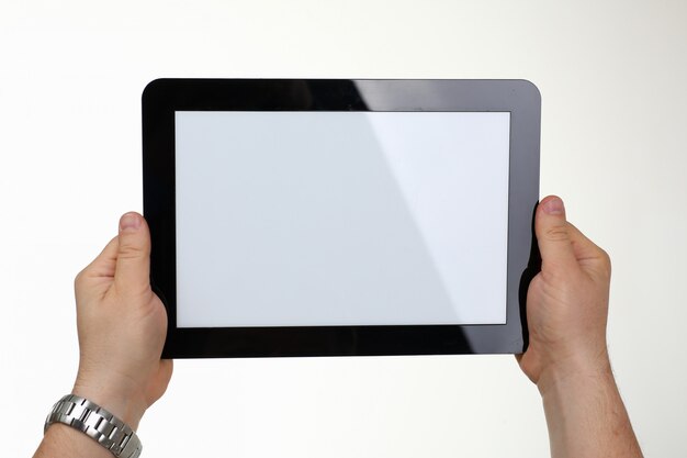 Man is holding digital tablet in studio