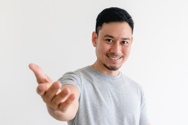 Man is making a hand gesture of invitation or offers help.