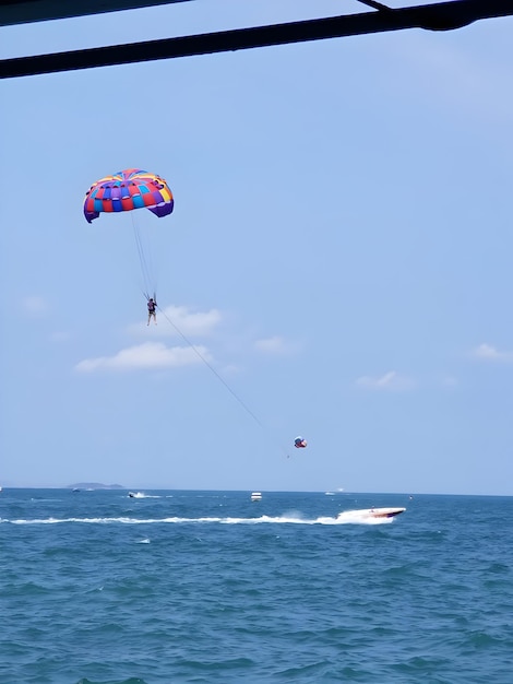 a man is parasailing in the water with a parachute