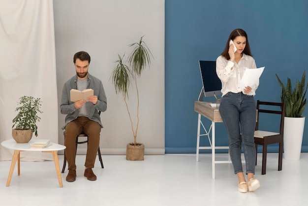 Man is reading while woman talking on mobile