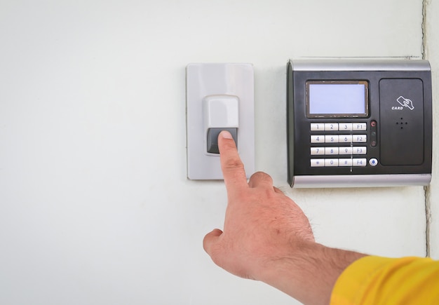 The man is ringing doorbell of office building.