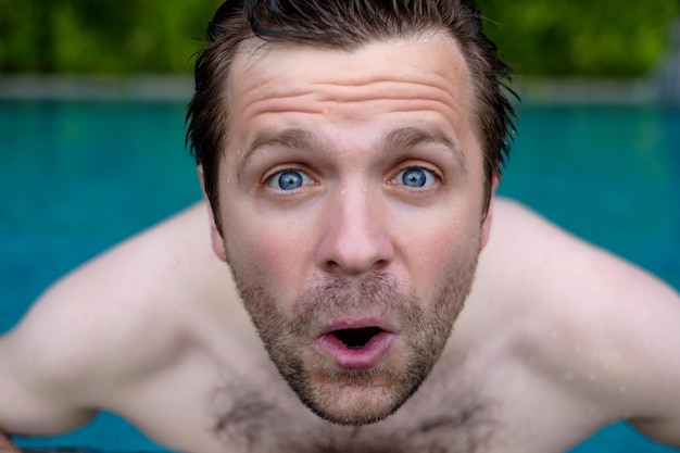 Man is shocked with news He is closing his mouth He is swimming in pool during vacation