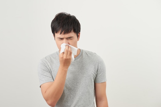 Man is sick and sneezing with white background asian