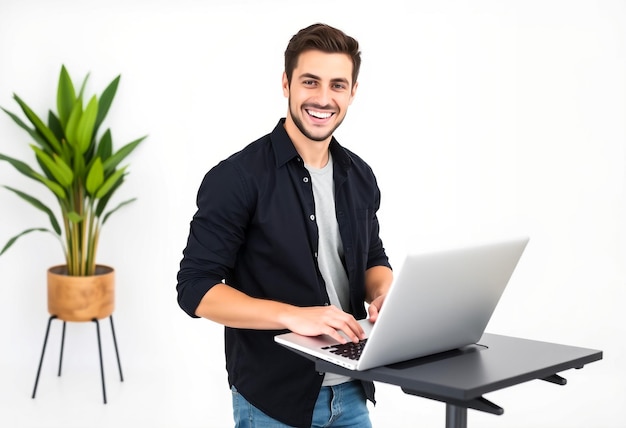 a man is smiling while using a laptop