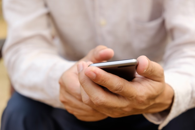 The man is using the phone.