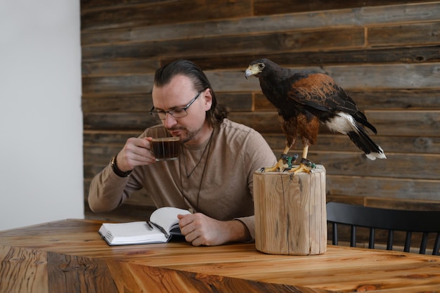 Man is working writing with wild eagle bird