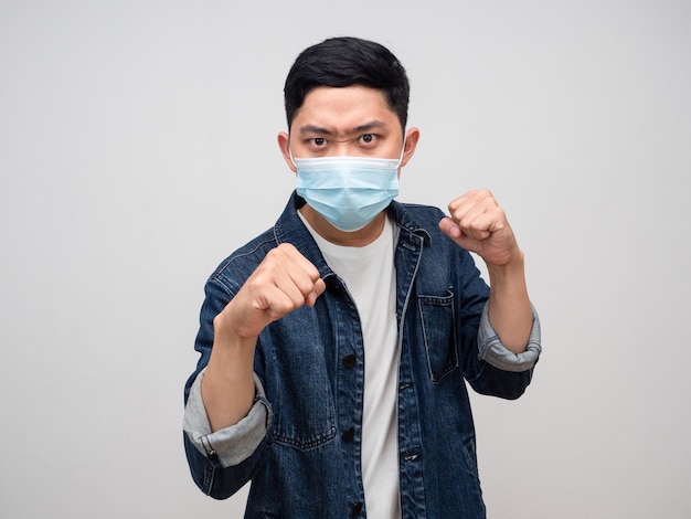 Man jeans shirt wear medical mask gesture punching for fighting with epidemic isolated