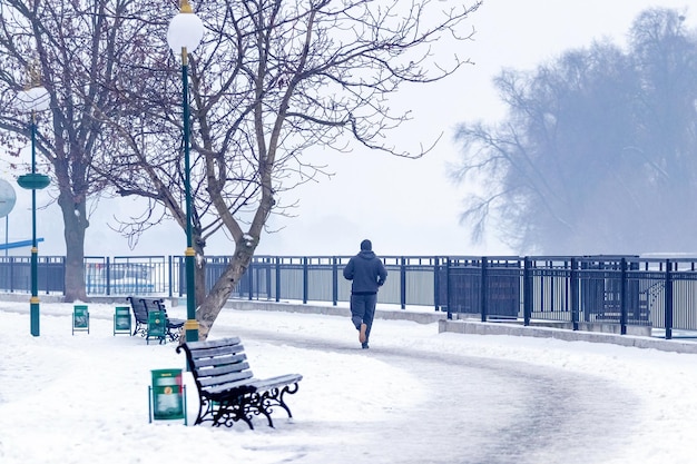 Man jogging in winter park healthy lifestyle