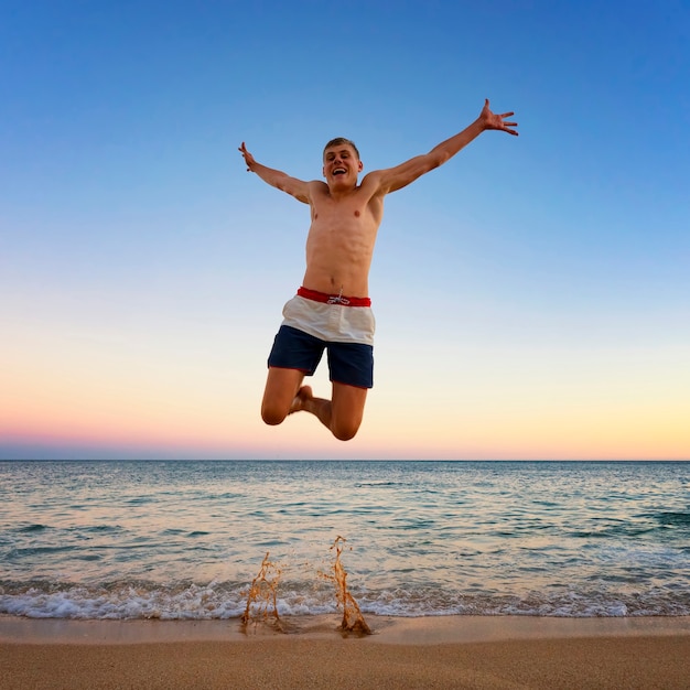 Photo man jumping at camilo beach, portugal