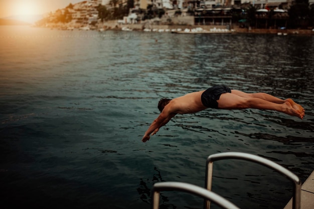 Man jumping into the ocean. Summer fun lifestyle.