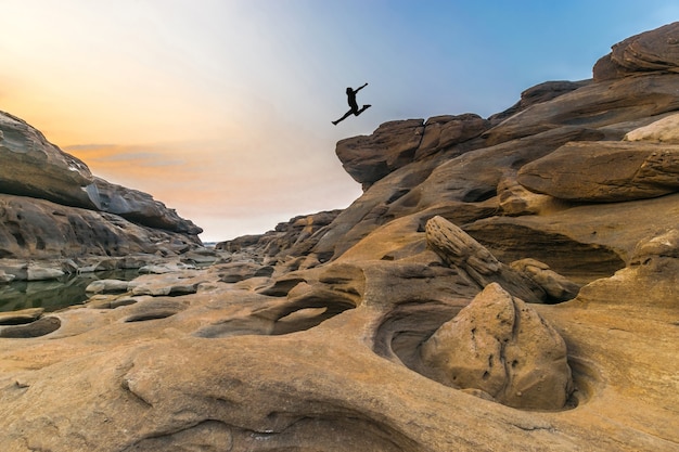 man jumping over the rock