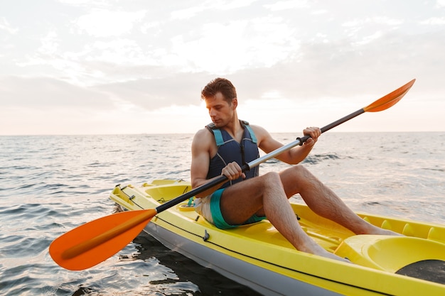  man kayaking on lake sea in boat.