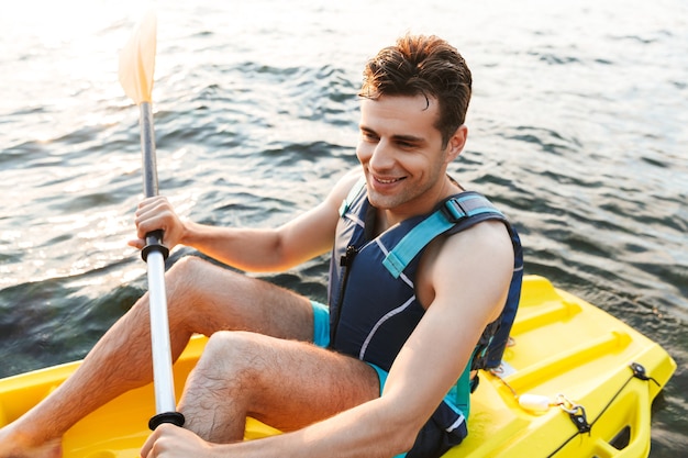  man kayaking on lake sea in boat.