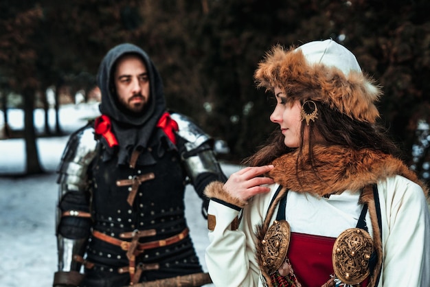 Man knight in armor and woman in historical costume