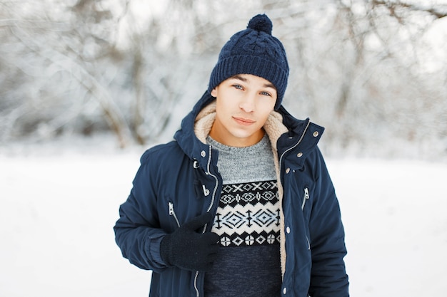 Man in knitted hat and knitted sweater with a pattern and a jacket