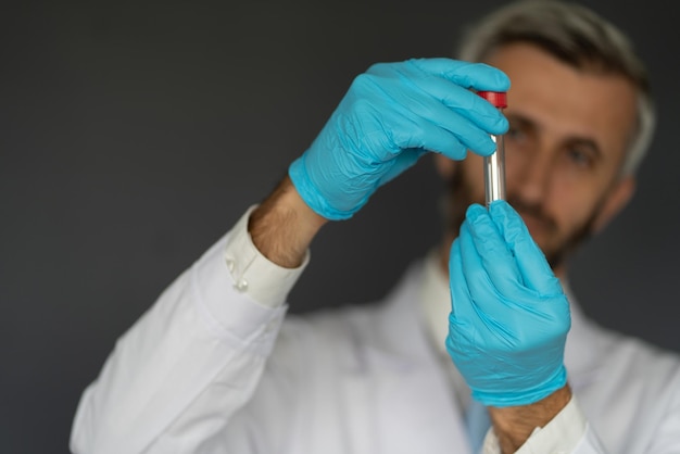 a man in a lab coat is holding a syringe in his hand